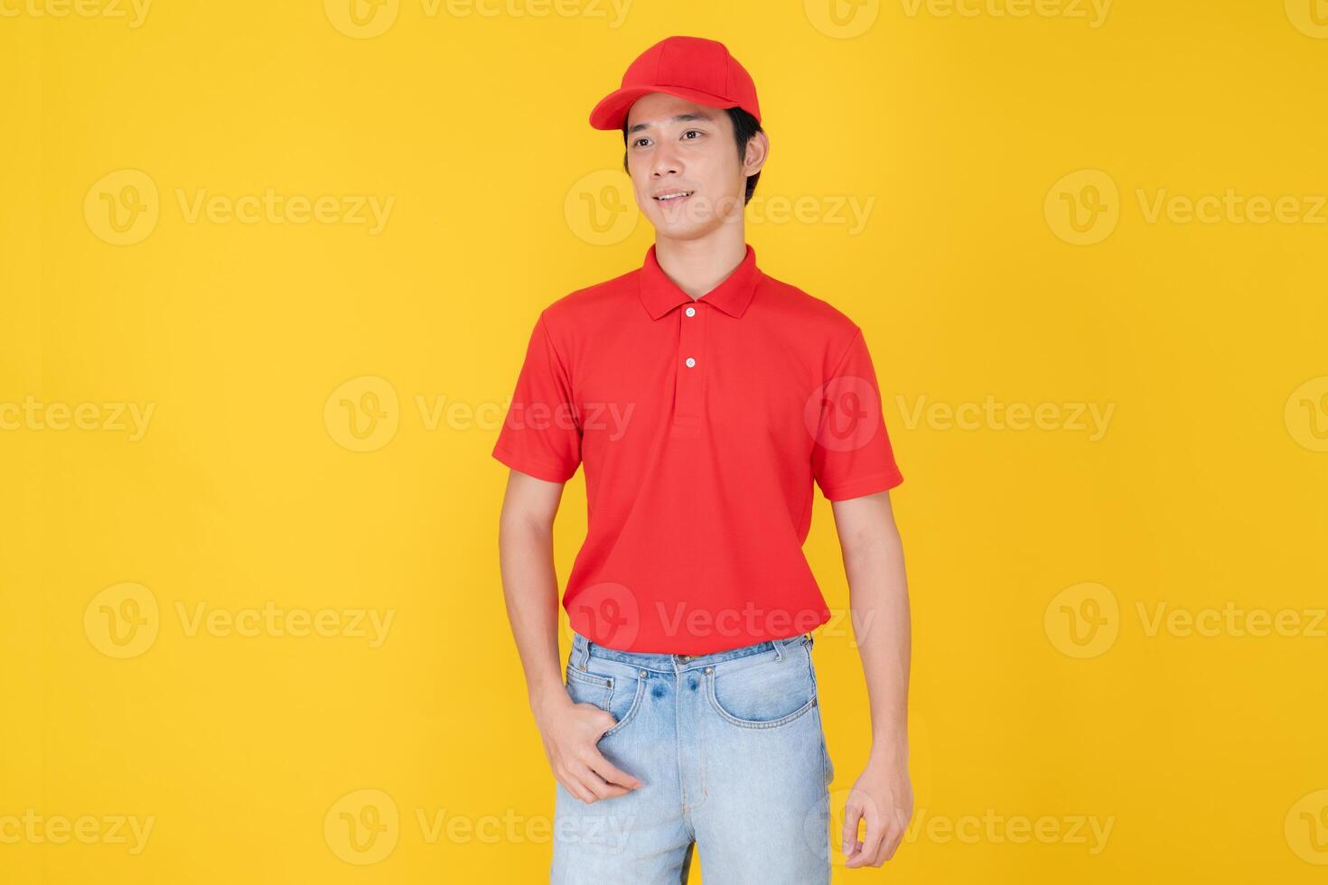 Confident delivery man standing on yellow background photo