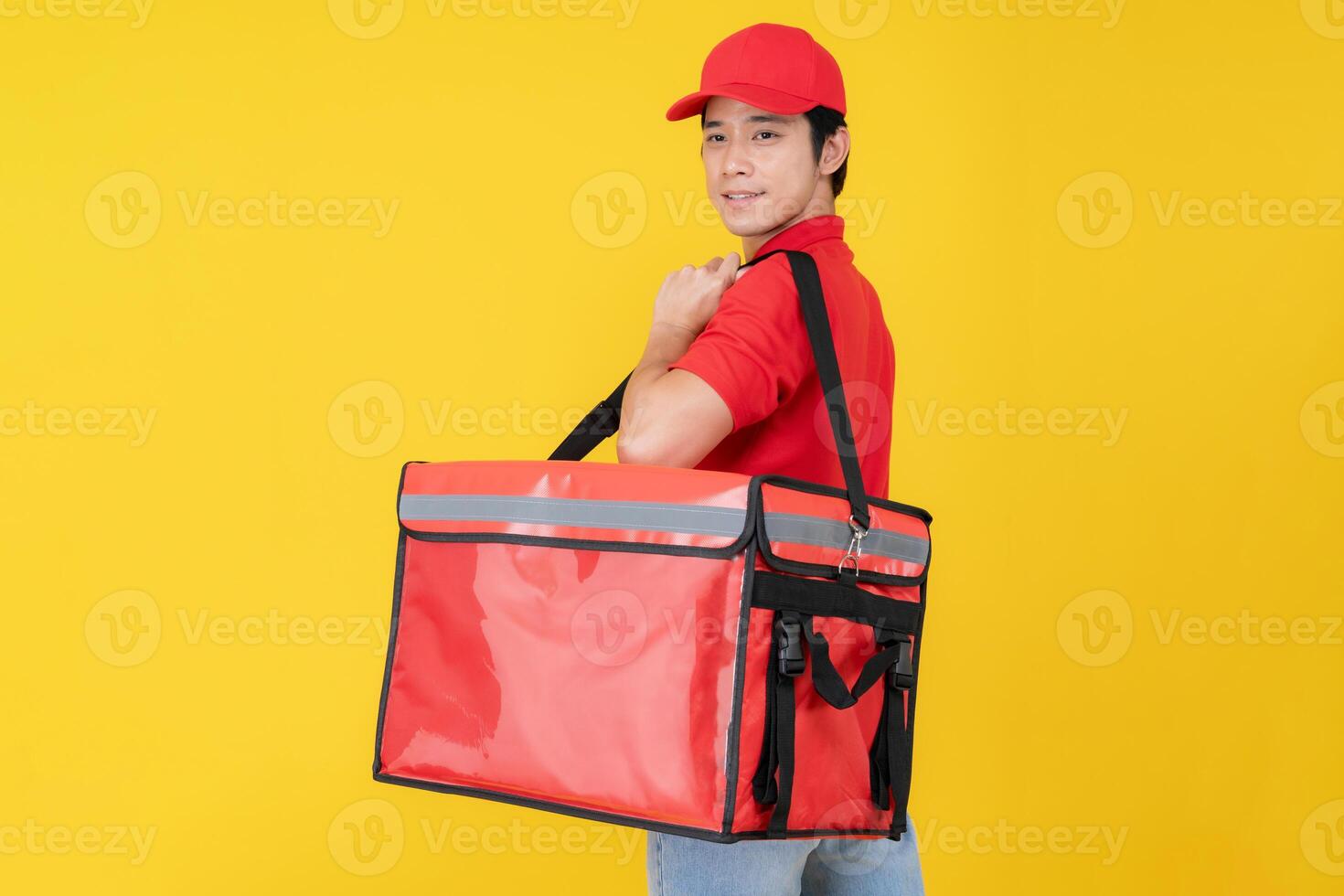 Cheerful delivery man holding insulated food bag photo