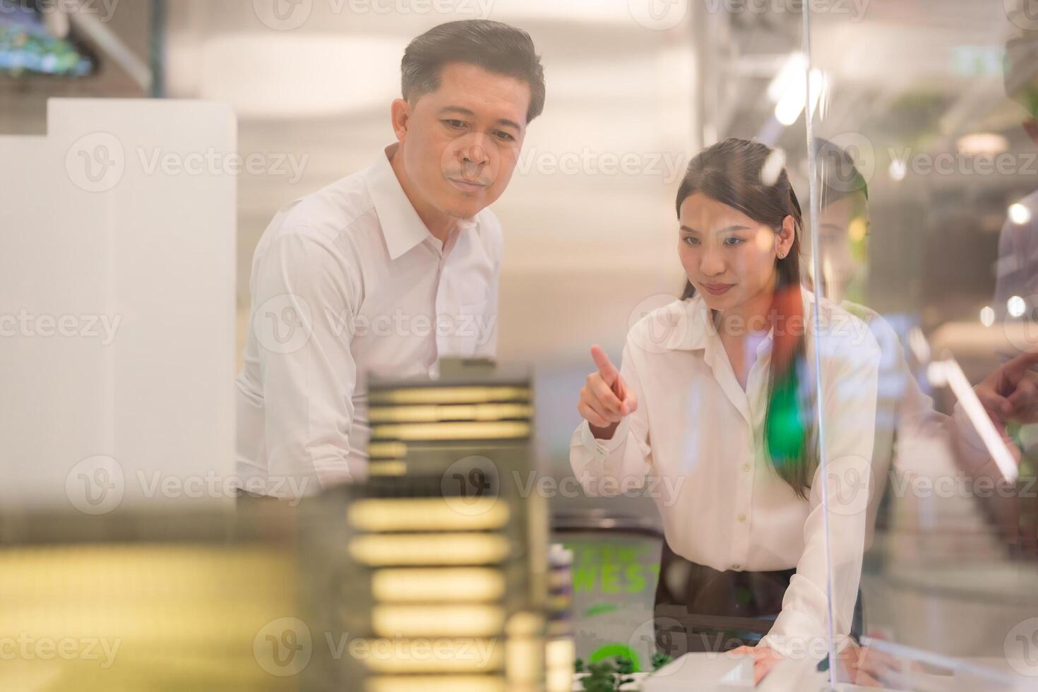 Colleagues collaborating on architectural model photo