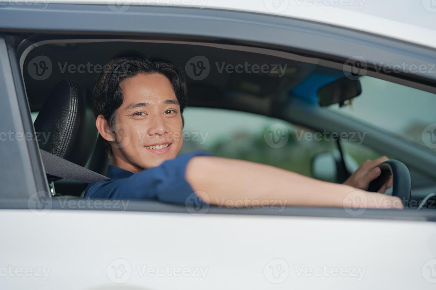 Confident young man driving car photo