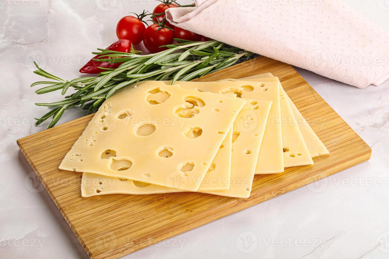 Sliced maasdam cheese with holes photo