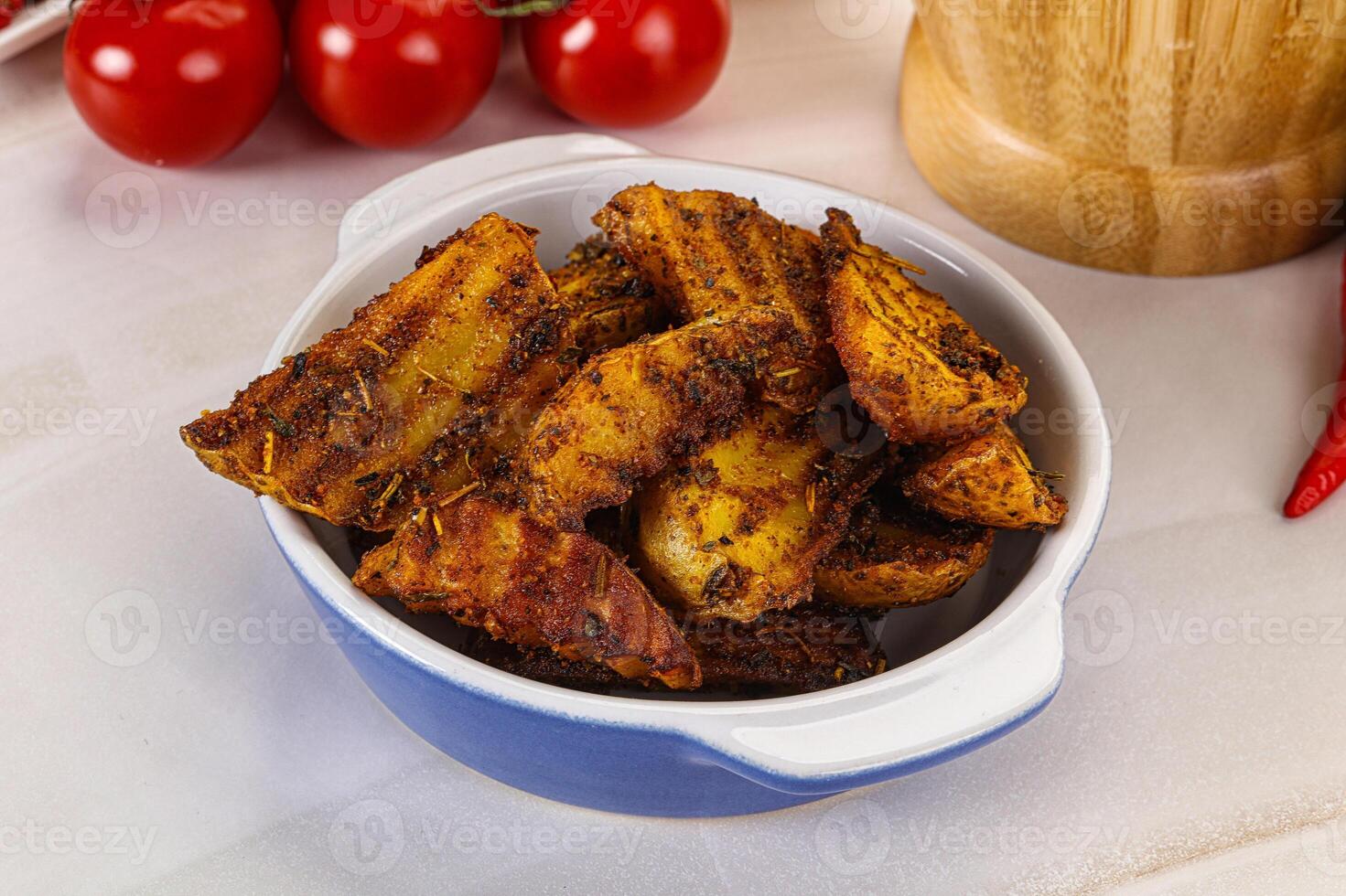 Golden baked potato Idaho with spices photo