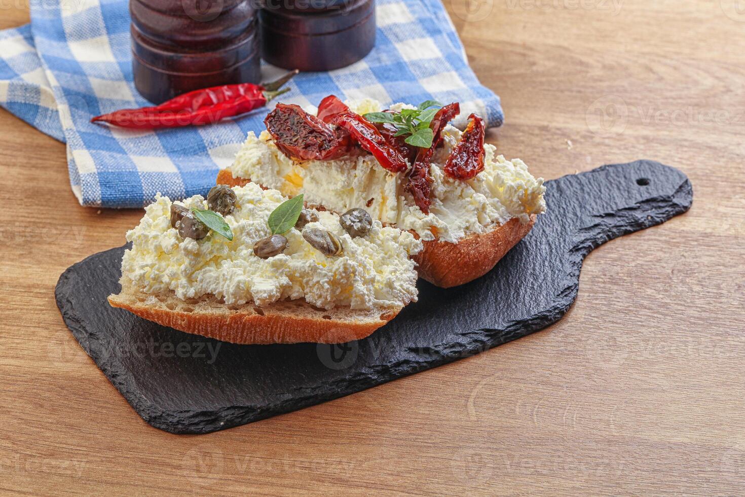 bruschetta with soft cheese capers and tomato photo