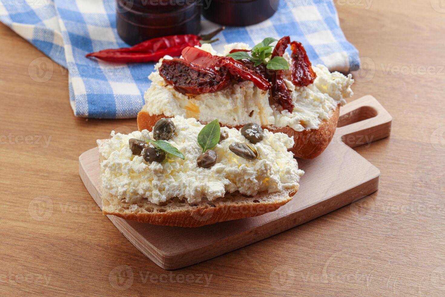 bruschetta with soft cheese capers and tomato photo