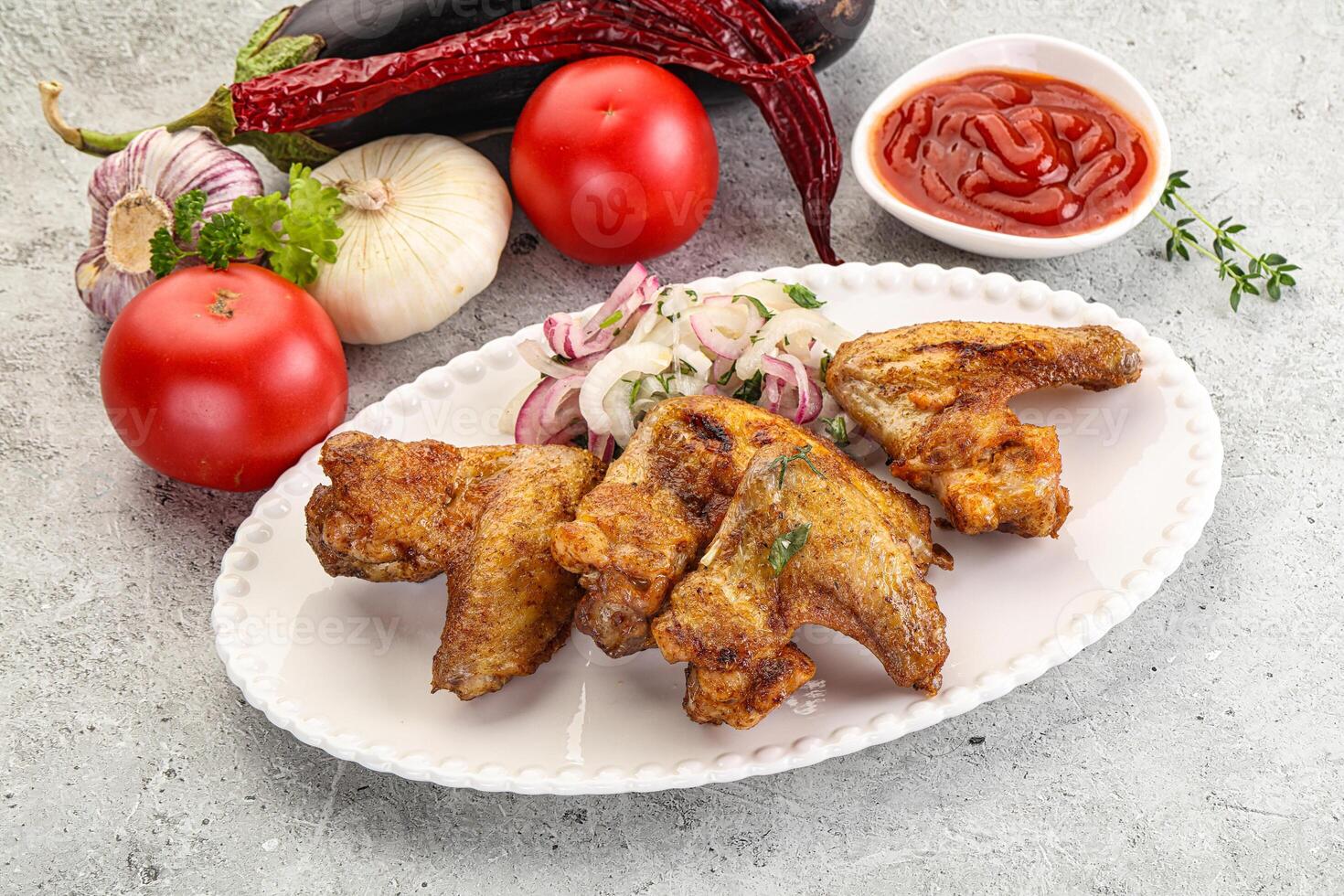 Grilled chicken wings with sauce photo
