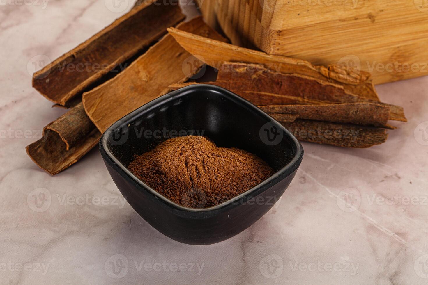 Natural Cinnamon powder with sticks photo