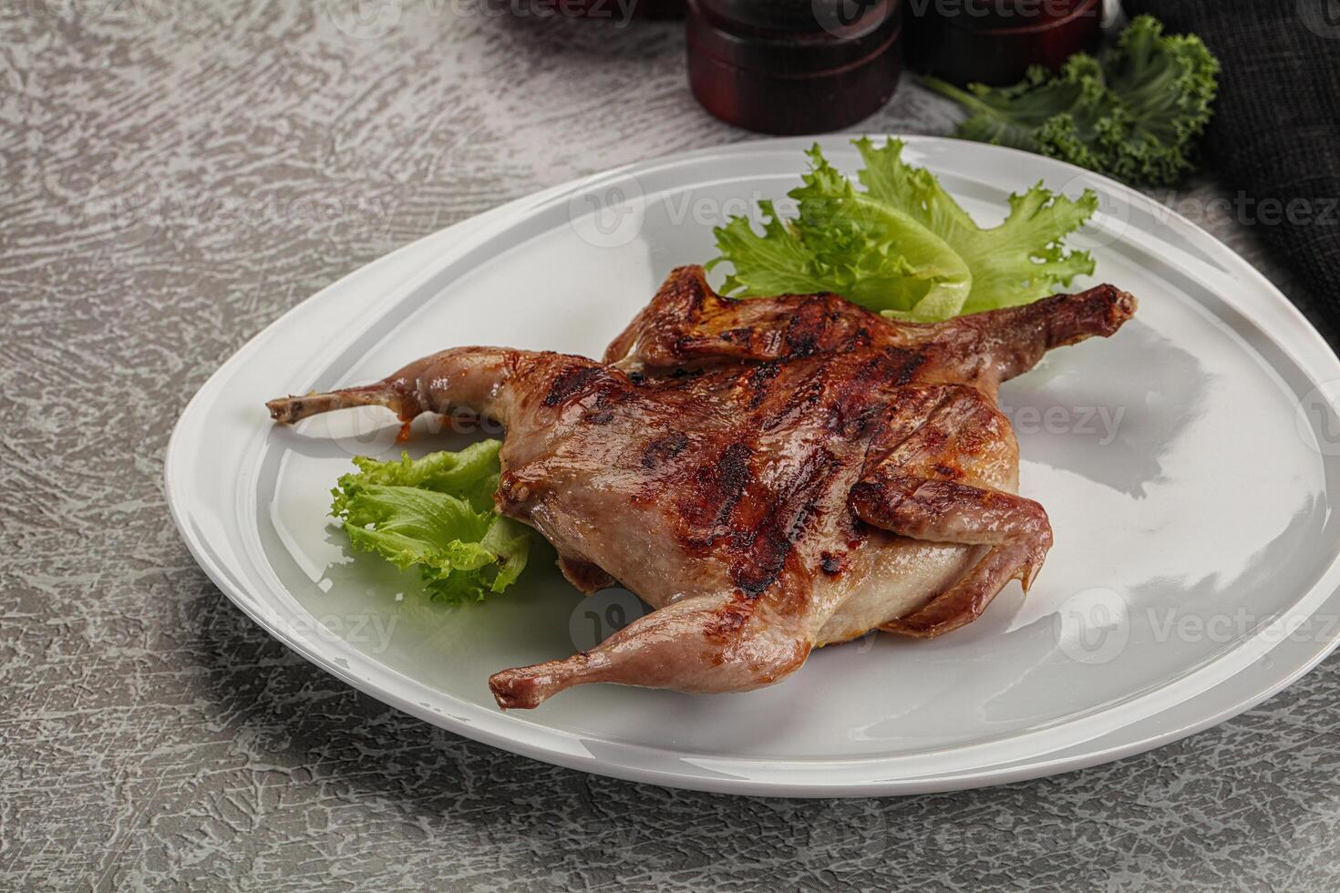 Grilled quail in the plate photo