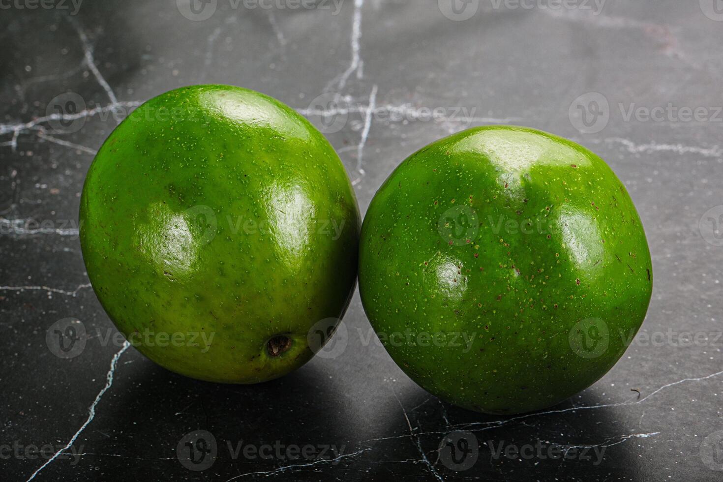 Two ripe green exotic avocado fruit photo