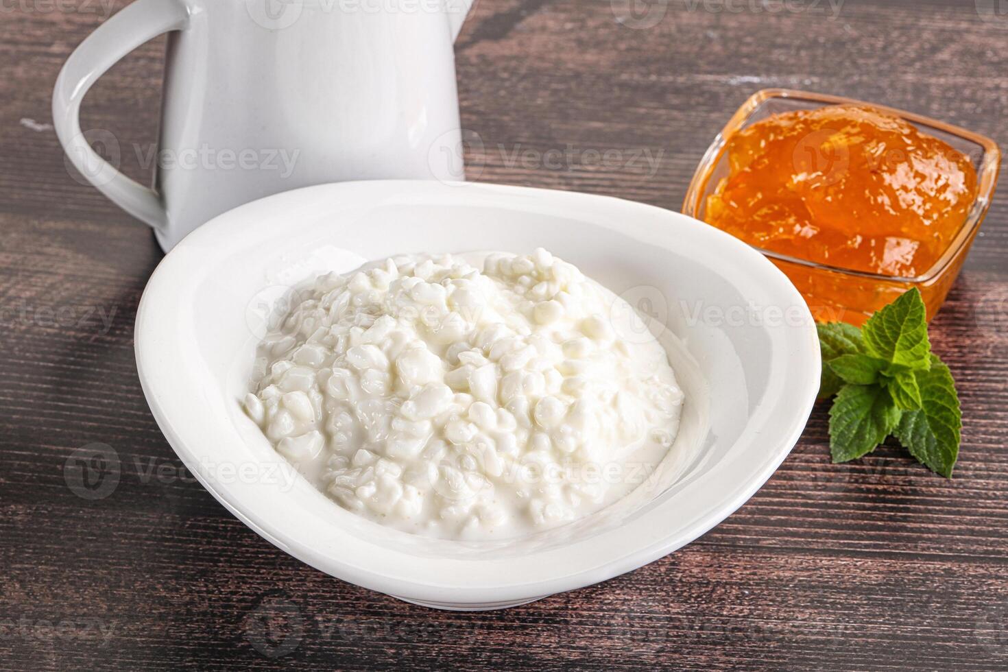 Grain curd with cream and jam photo