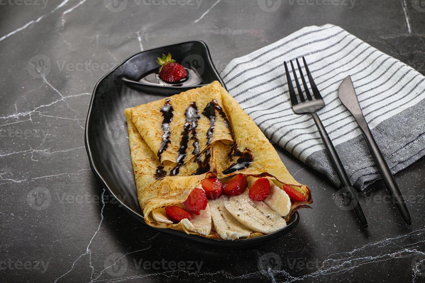 Sweet pancake with banana and strawbeery photo