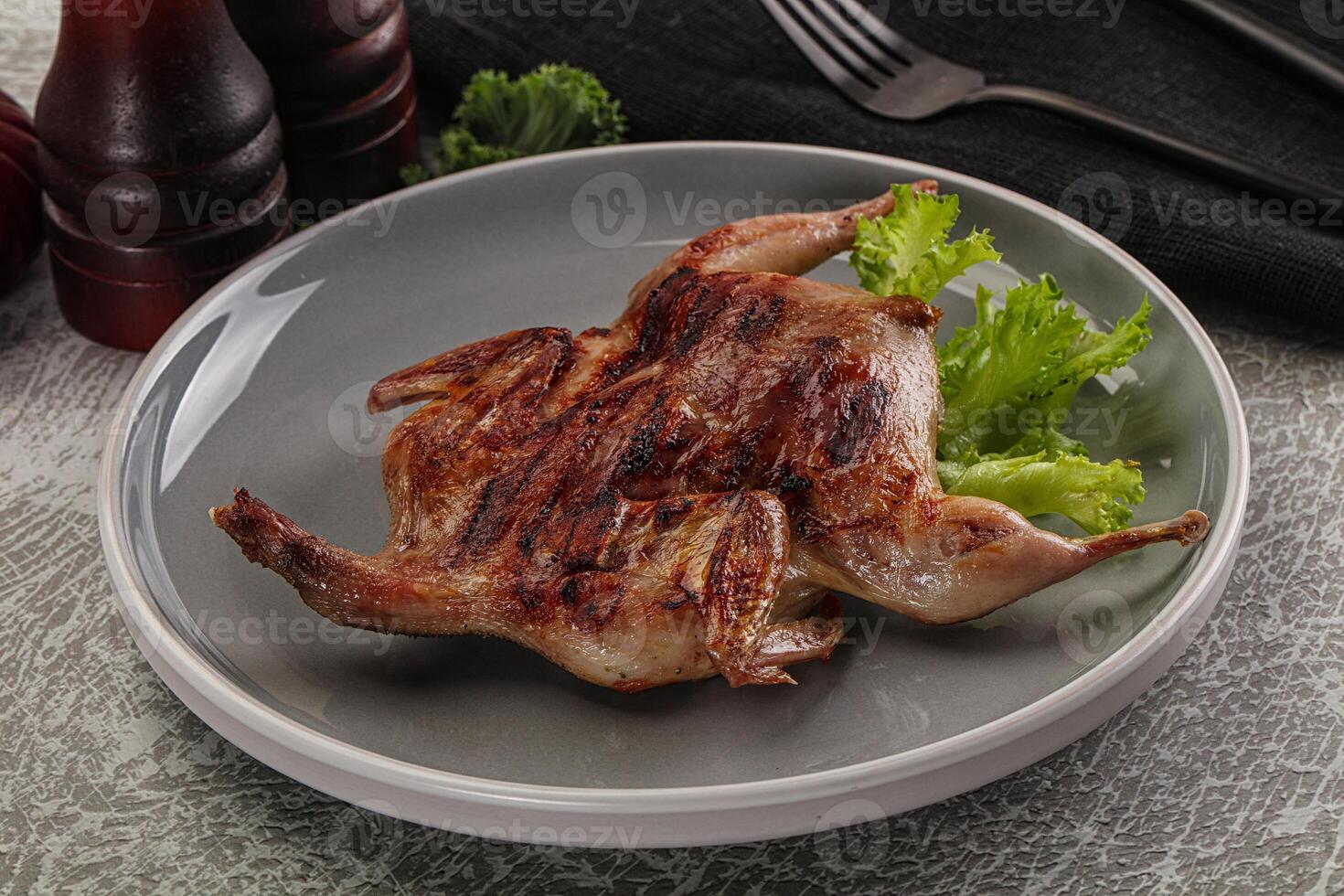 Grilled quail in the plate photo
