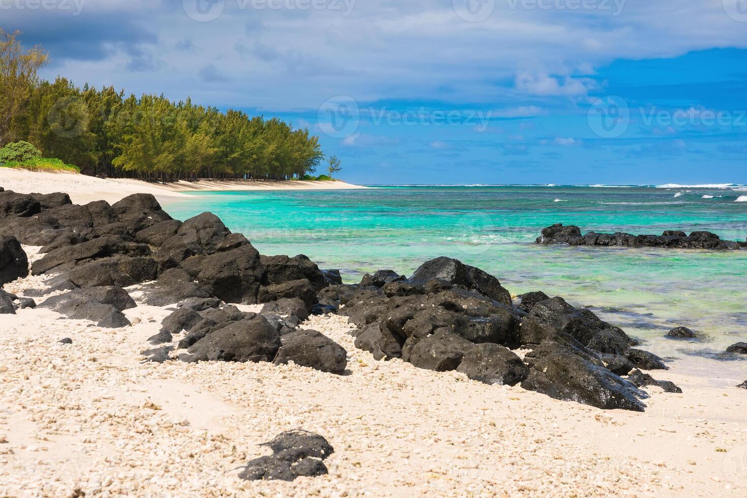 Beautiful tropical beach with sand, rocks, transparent ocean and blue sky of Mauritius photo