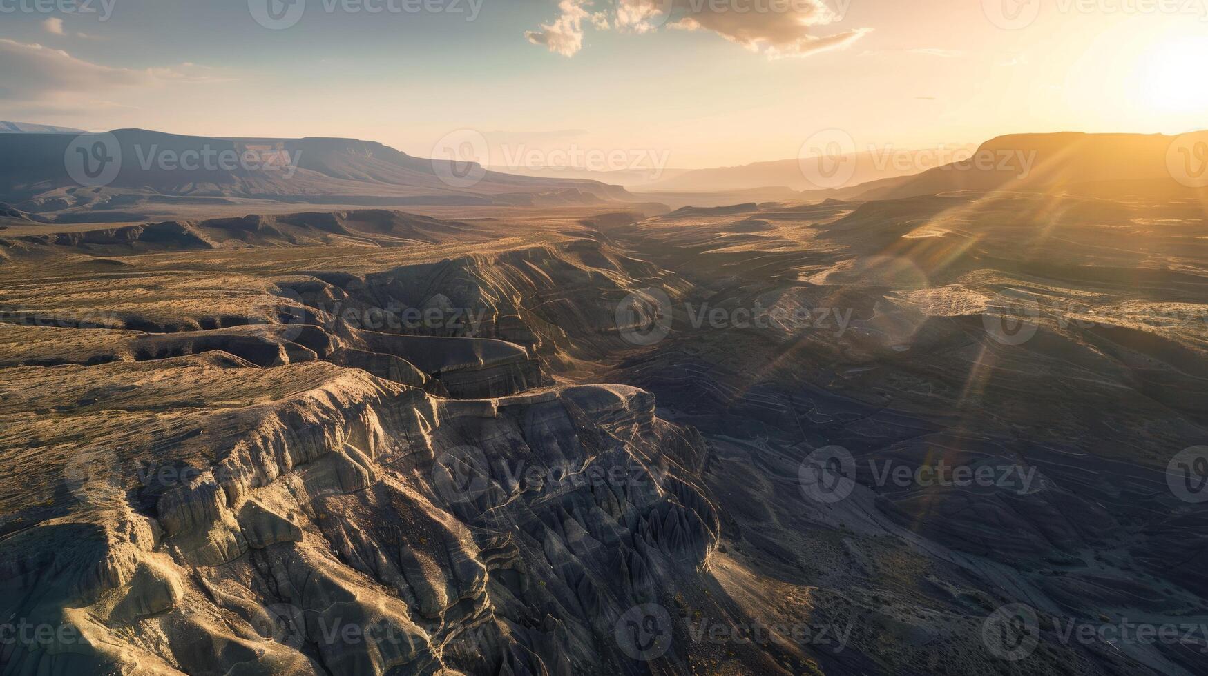 Sunset over canyon with sun shining through clouds in aerial view photo