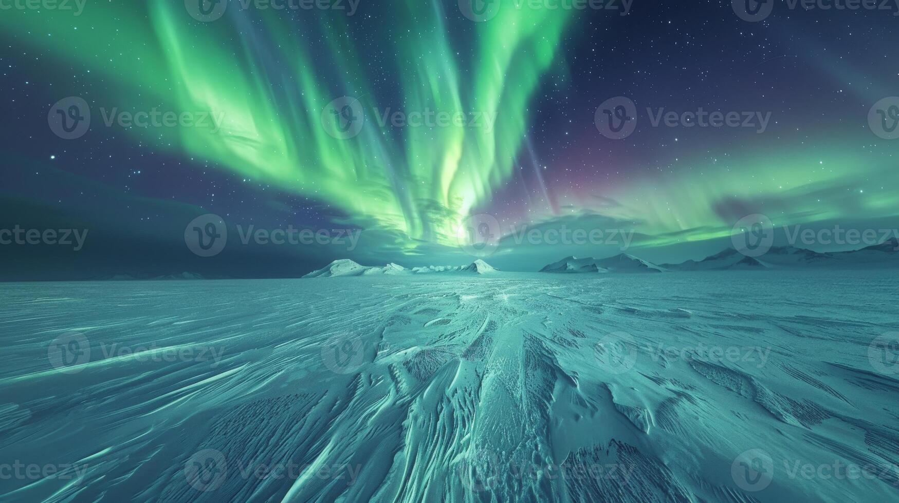 Aurora borealis lights up snowy field with electric blue hues in the darkness photo