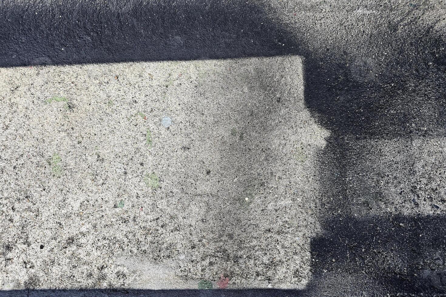 Black Grunge Painting on Concrete Wall Background photo