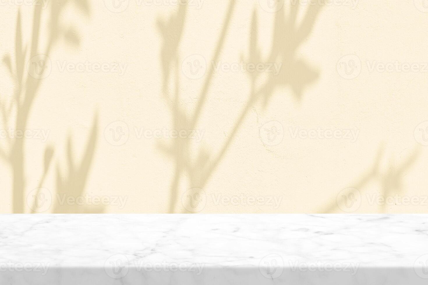 Minimal white marble table with tree shadow on beige concrete wall texture background photo