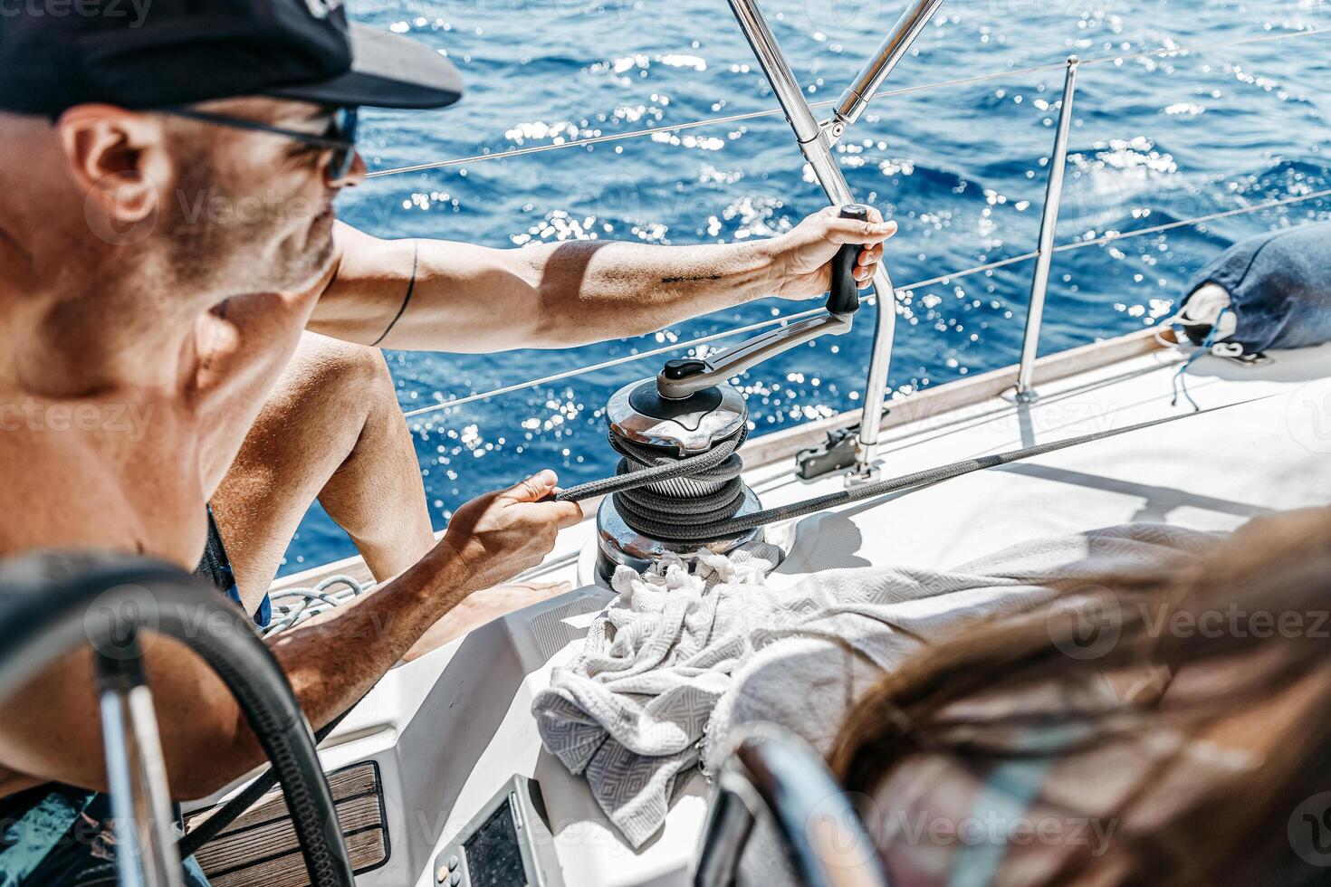 Handsome Sailor Working on Sailboat photo