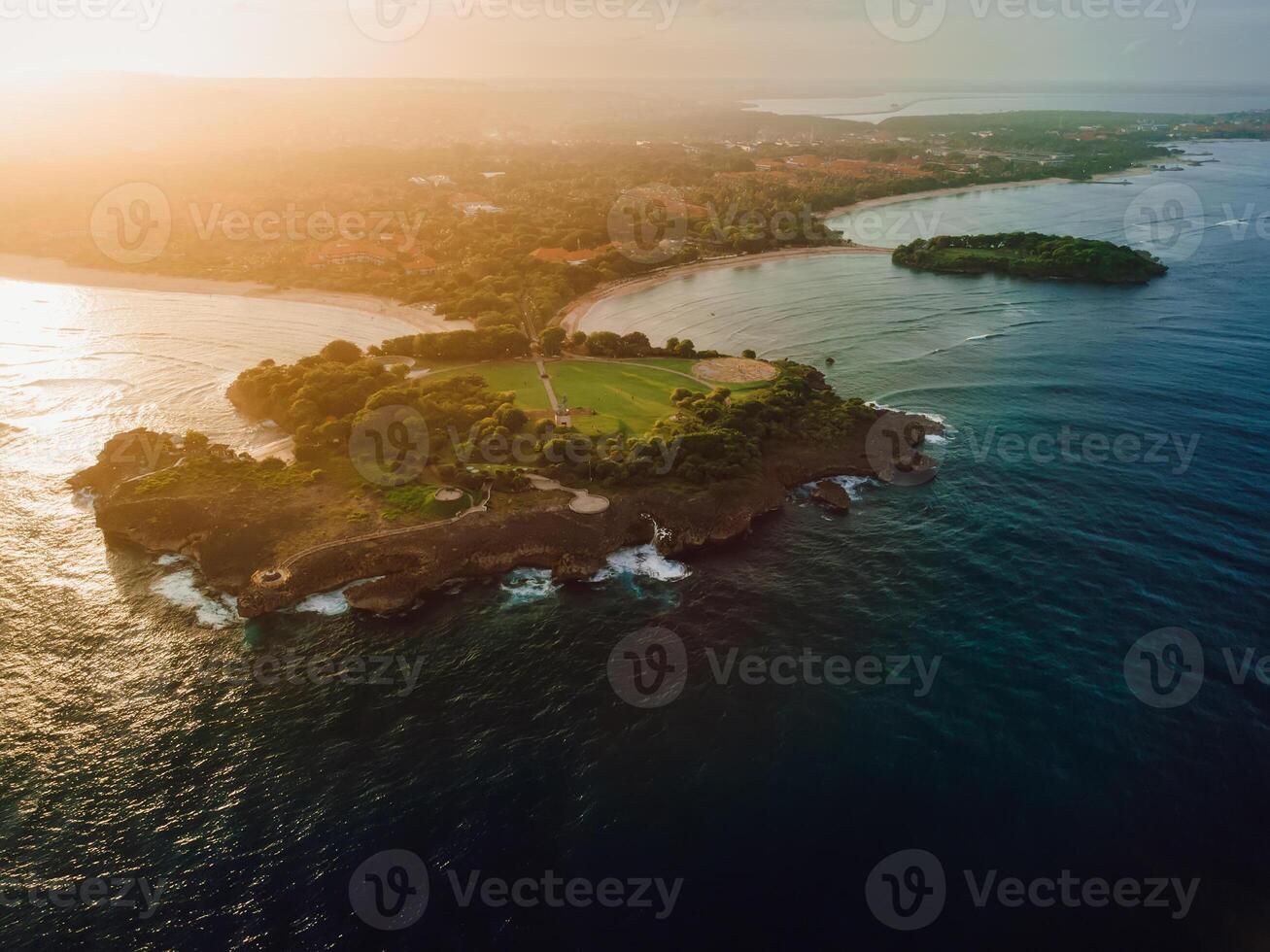 Aerial view of scenic coastline with islands, sunset tones and ocean in Nusa Dua, Bali photo