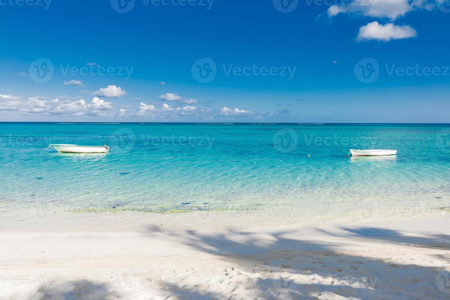 Tropical beach with transparent ocean and boat in Mauritius photo