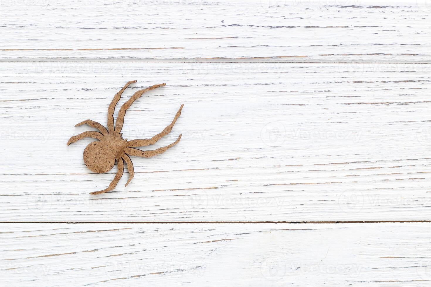 Wooden spider toy on a wooden background, Halloween concept photo