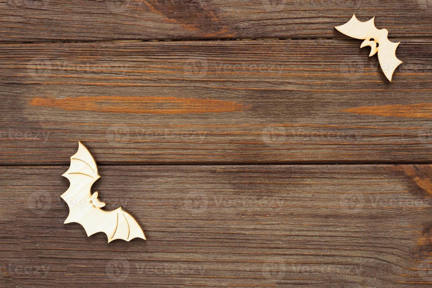 Wooden bat toy on a wooden background, Halloween concept photo