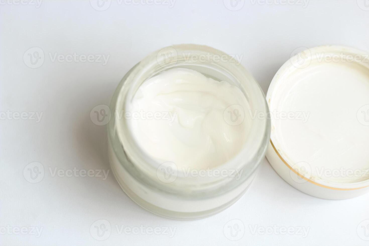 Moisturizing spf cream in a jar on a light background. photo