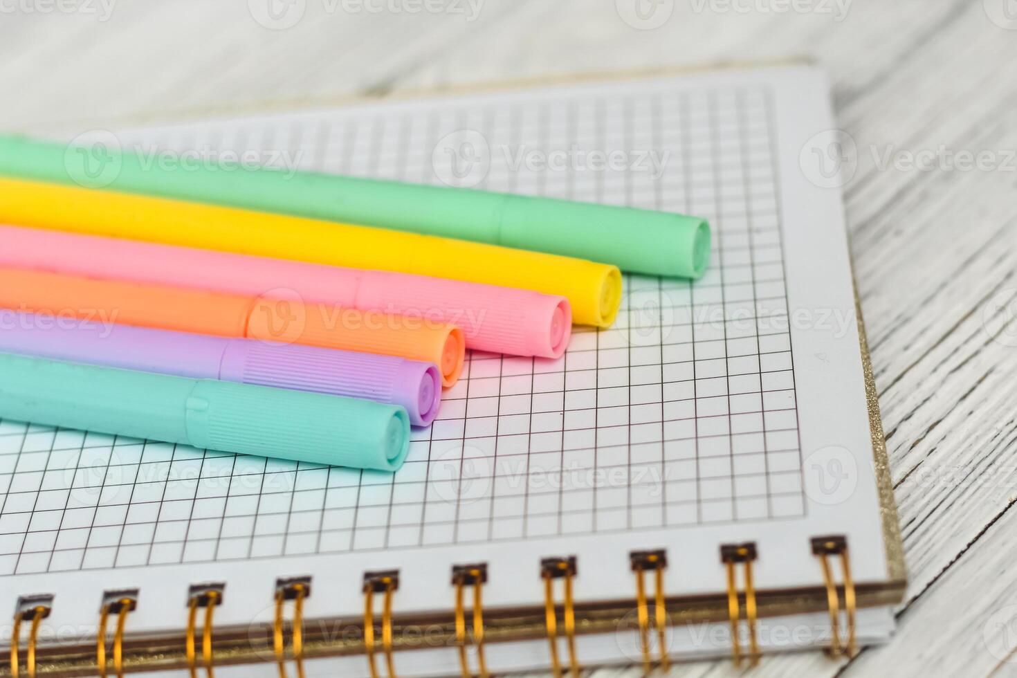 Notebook diary for planning and studying on the table with colored markers. photo