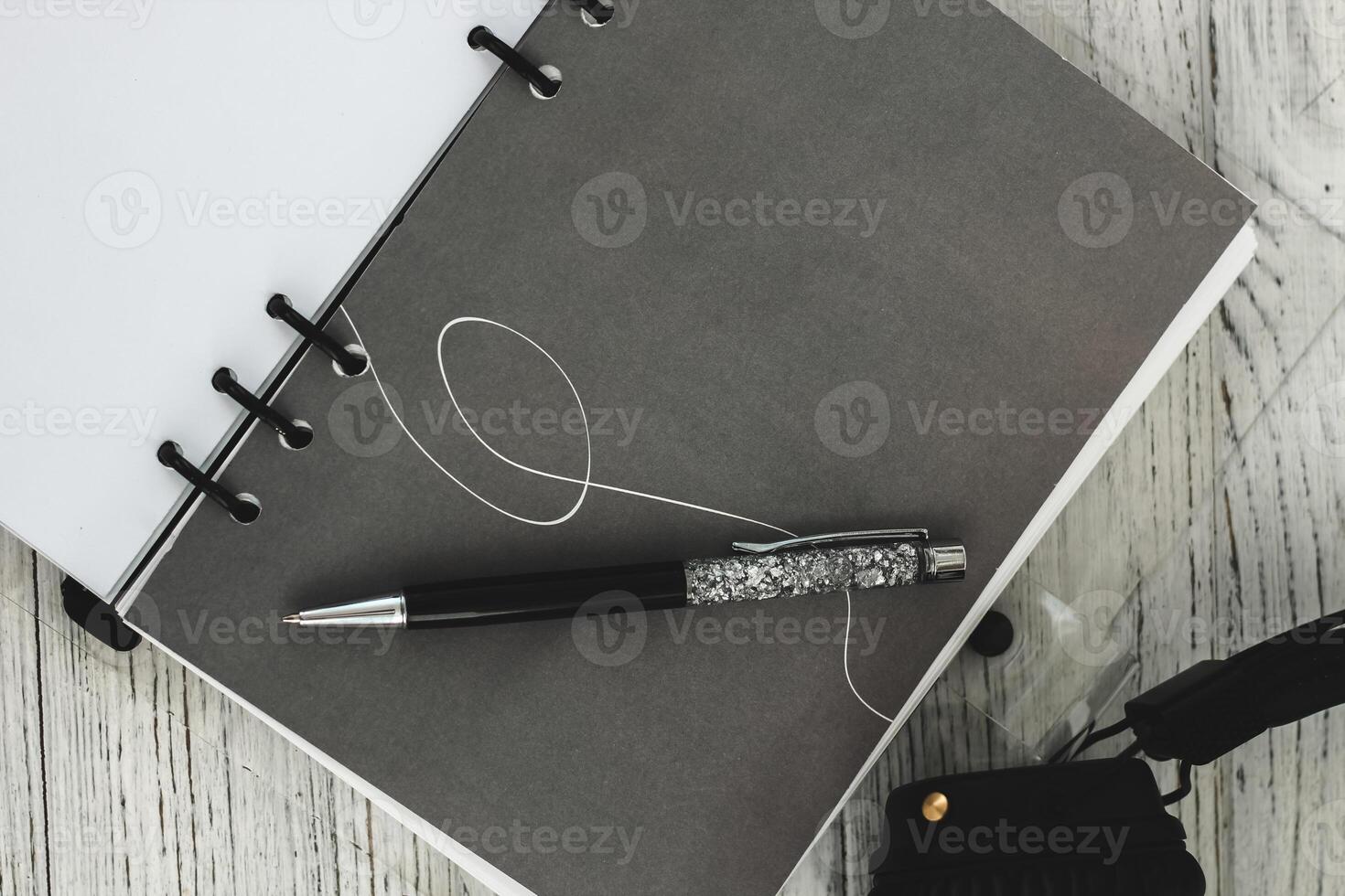 Notepad diary with pen on the desktop photo