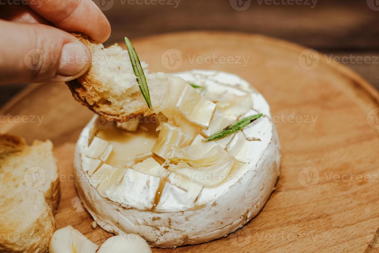 White baguette with olive oil and baked Camembert cheese on the table. photo
