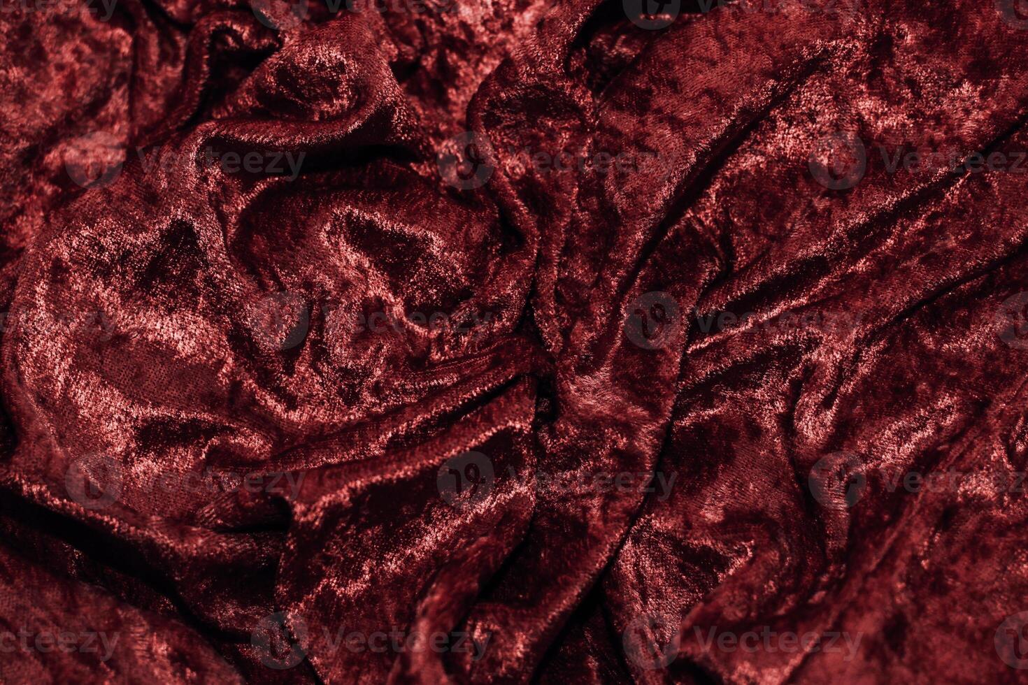 Texture of red velor corduroy fabric with folds photo