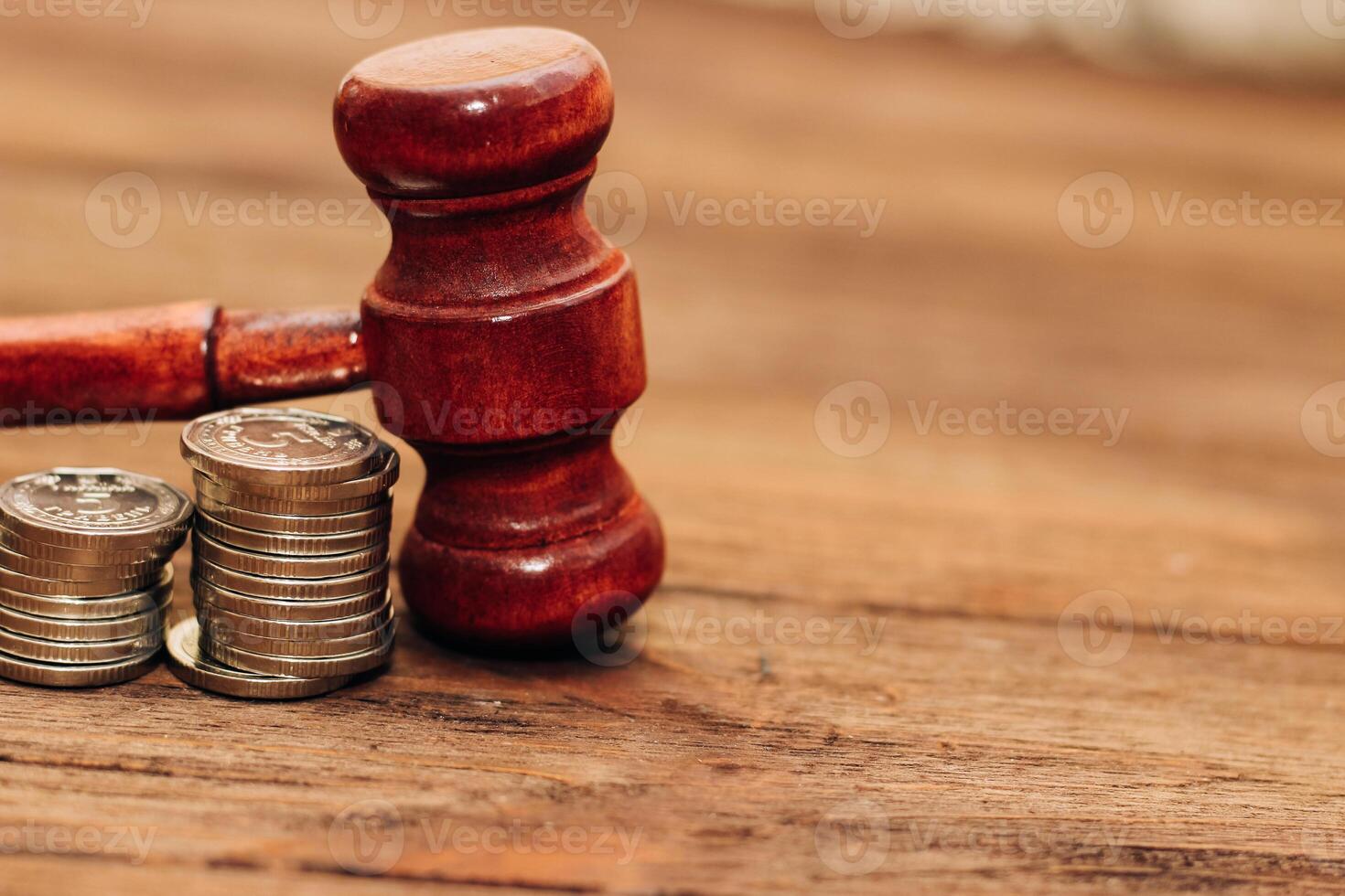 Judge's gavel on the table with Ukrainian hryvnias in coins. photo