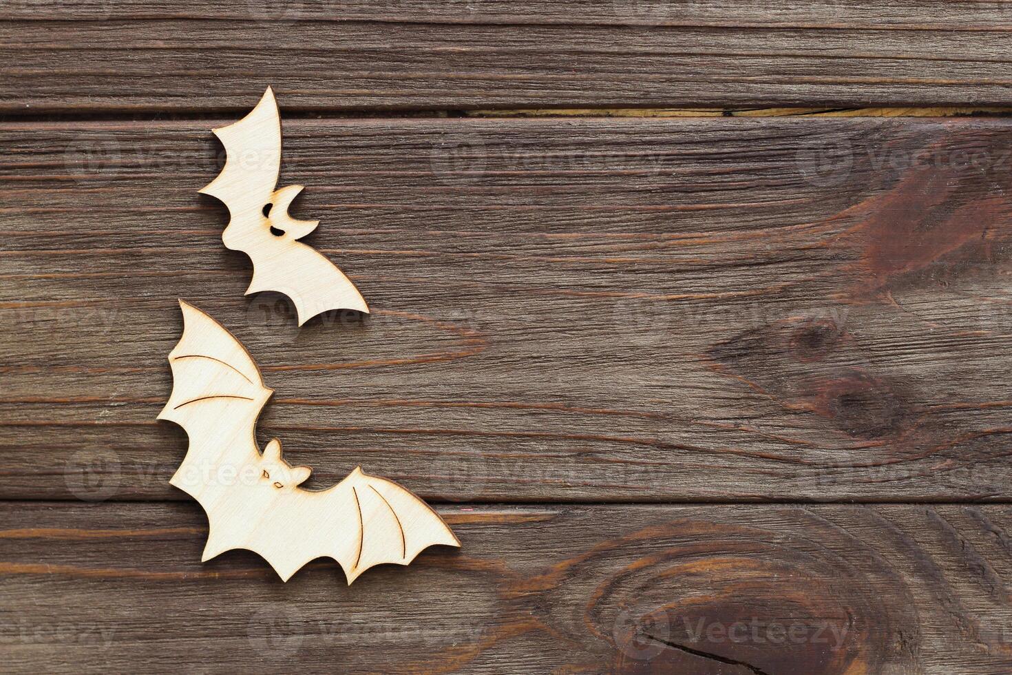 Wooden bat toy on a wooden background, Halloween concept photo