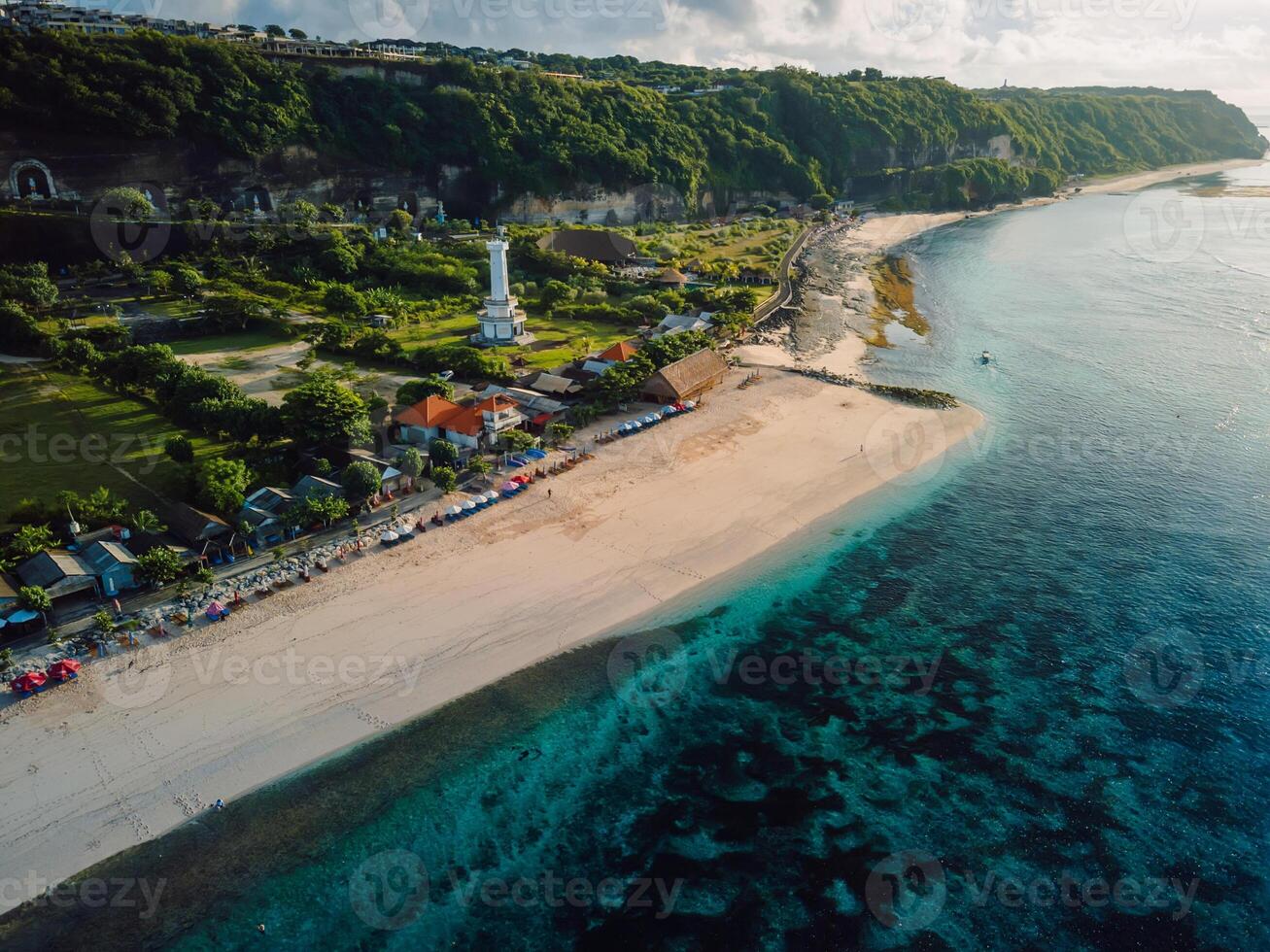 Most famous Pandawa beach with scenic landscape, lighthouse and ocean in Bali. photo