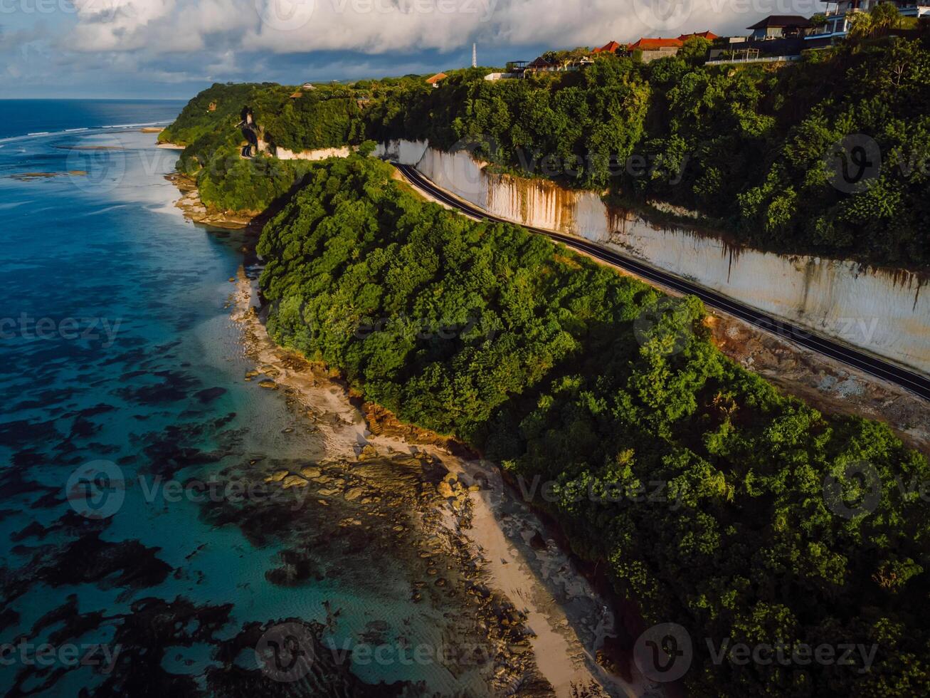 Panorama of coastline with ocean and road on cliff in Bali. Aerial view photo
