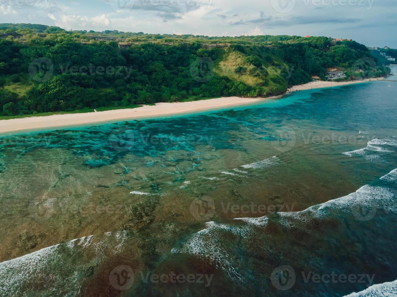 Scenic beach with cliffs and ocean on Bali. Aerial view of vacation coastline photo