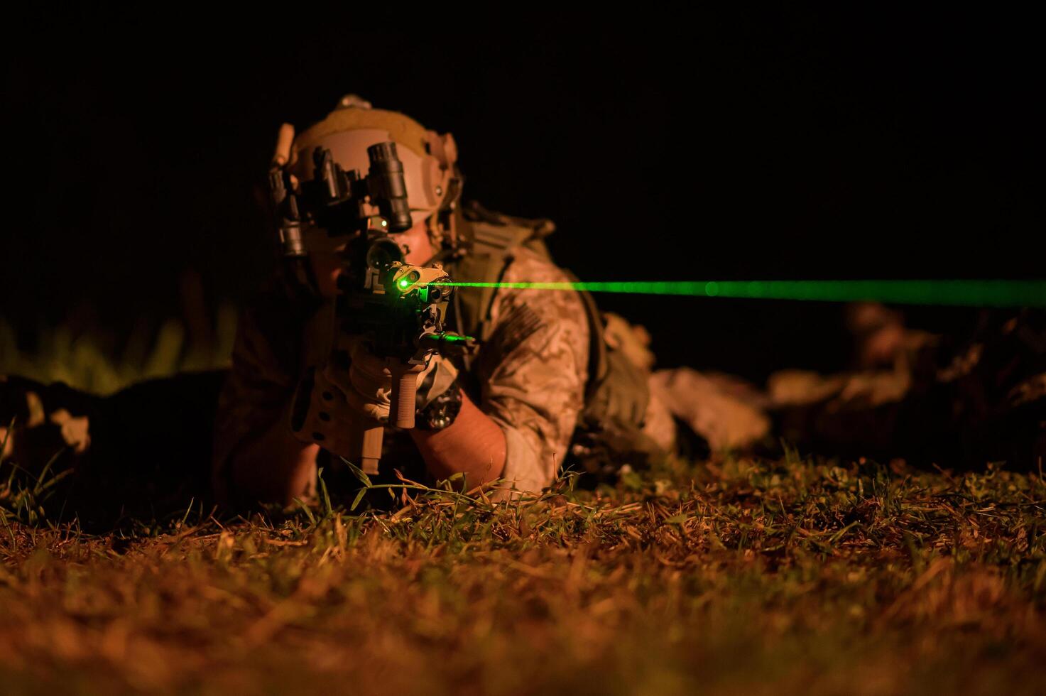 Soldiers in camouflage uniforms aiming with their riflesready to fire during Military Operation at night soldiers training in a military operation photo