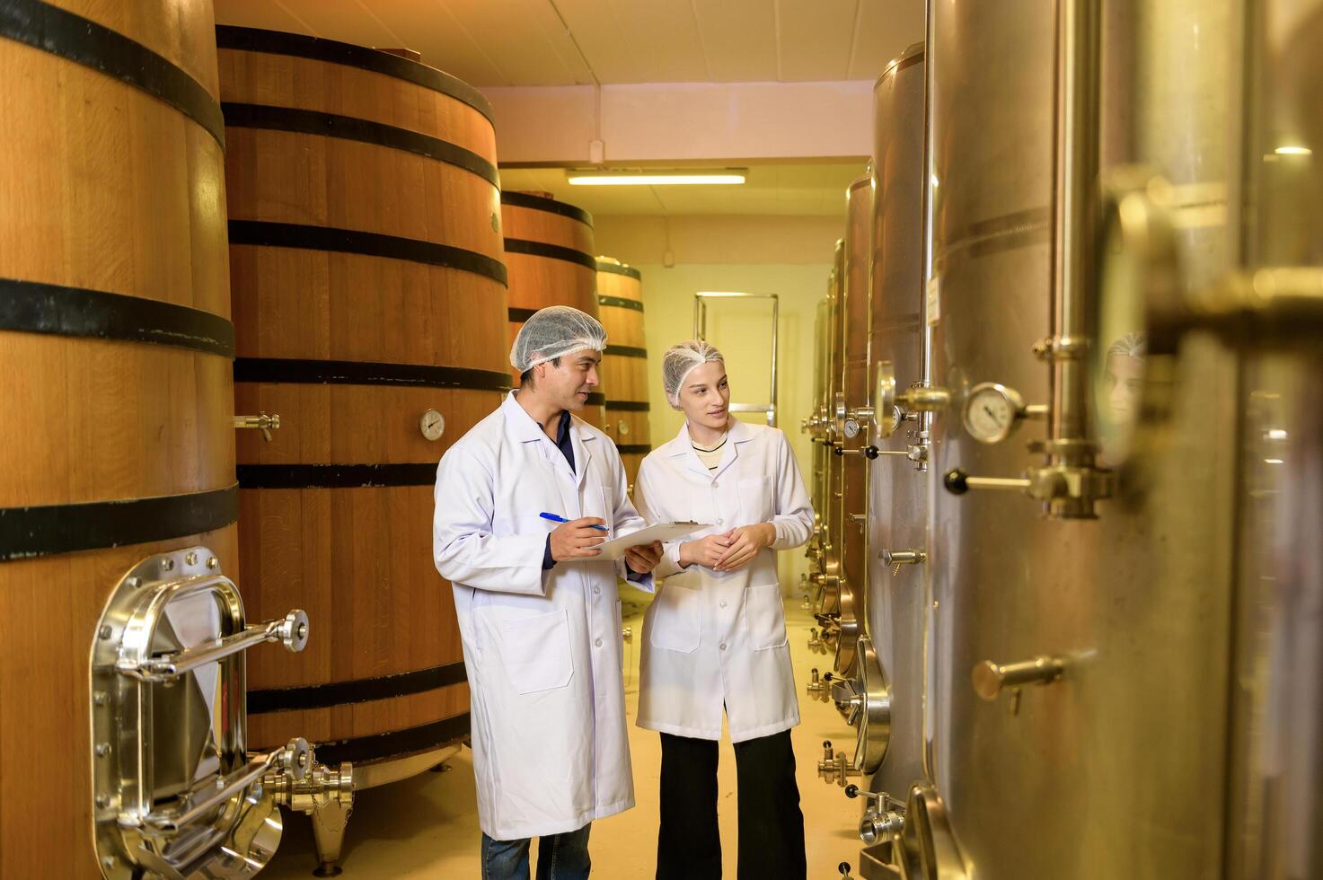 Professional winemaker controlling wine making process and quality at winery factory photo