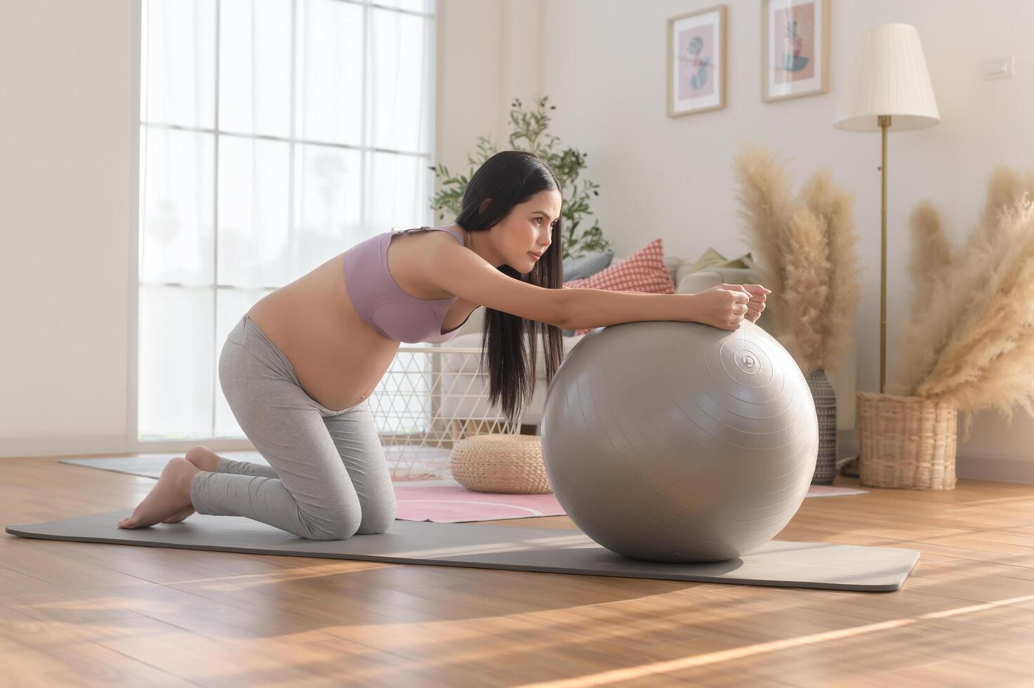 Healthy pregnant woman exercising and doing prenatal yoga, meditation, working out, yoga, pregnancy concept. photo