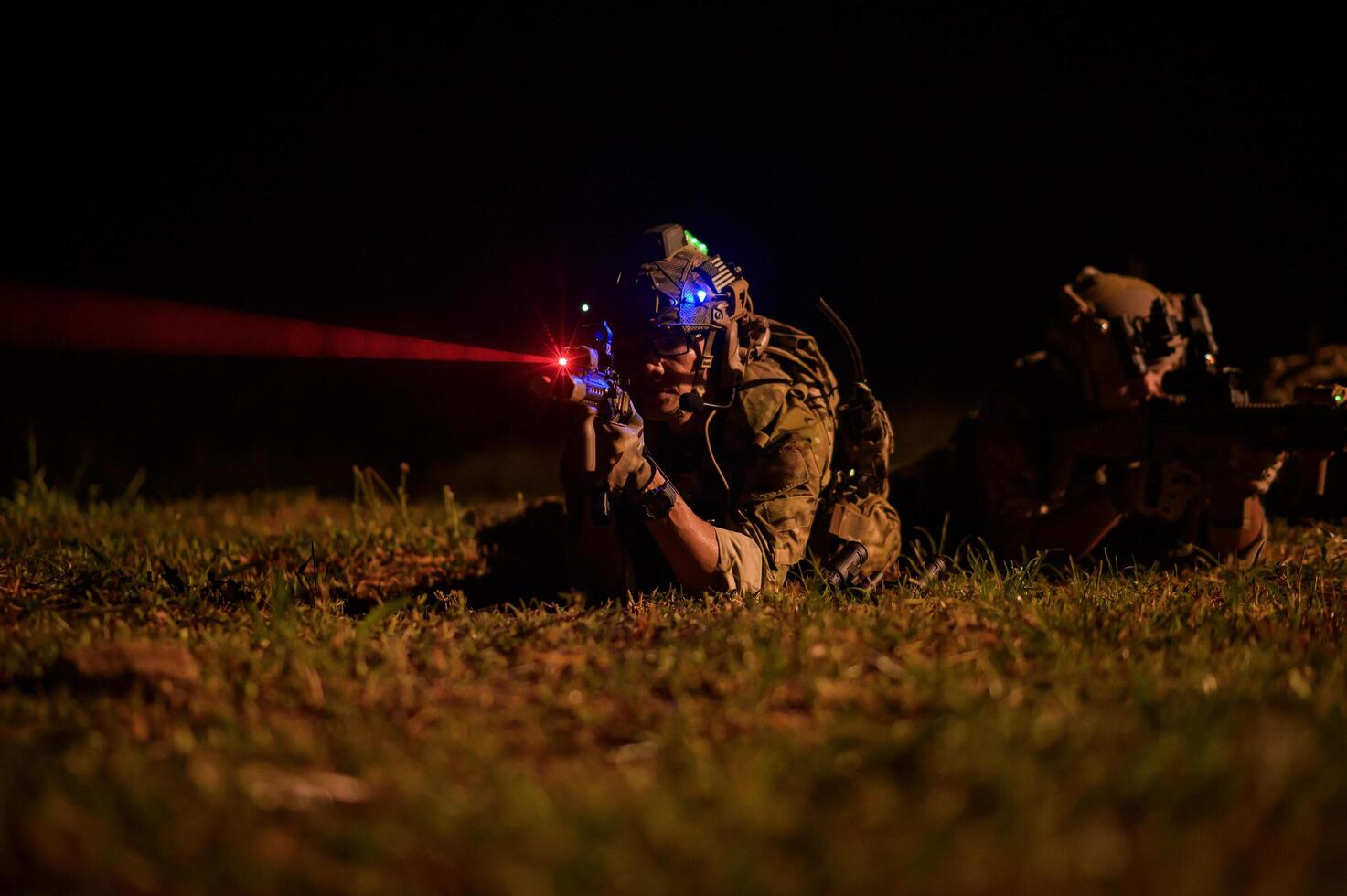 Soldiers in camouflage uniforms aiming with their rifles ready to fire during Military Operation at night, soldiers training in a military operation photo