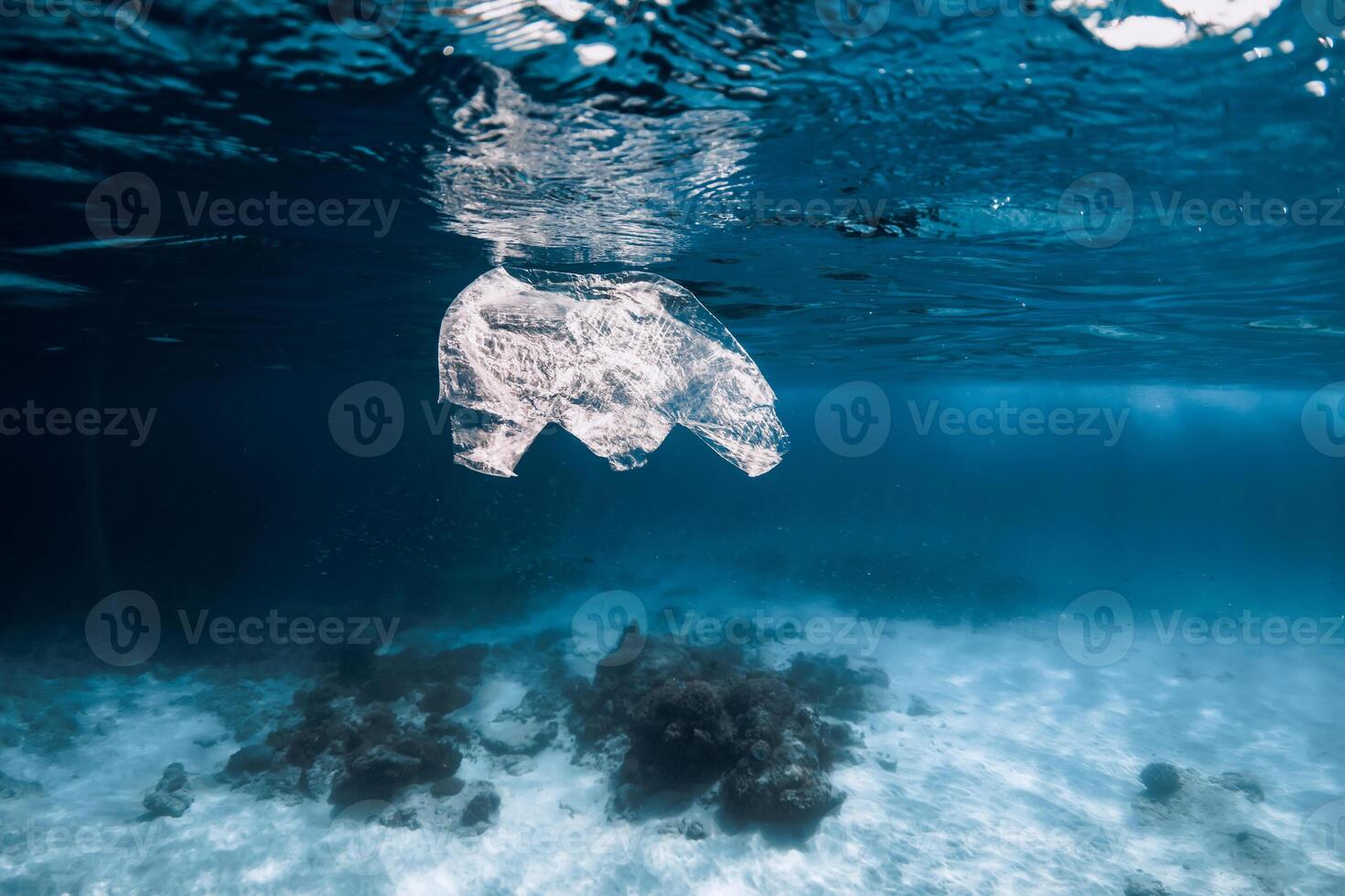 Underwater view in ocean with plastic bag and rubbish, ecological problem photo