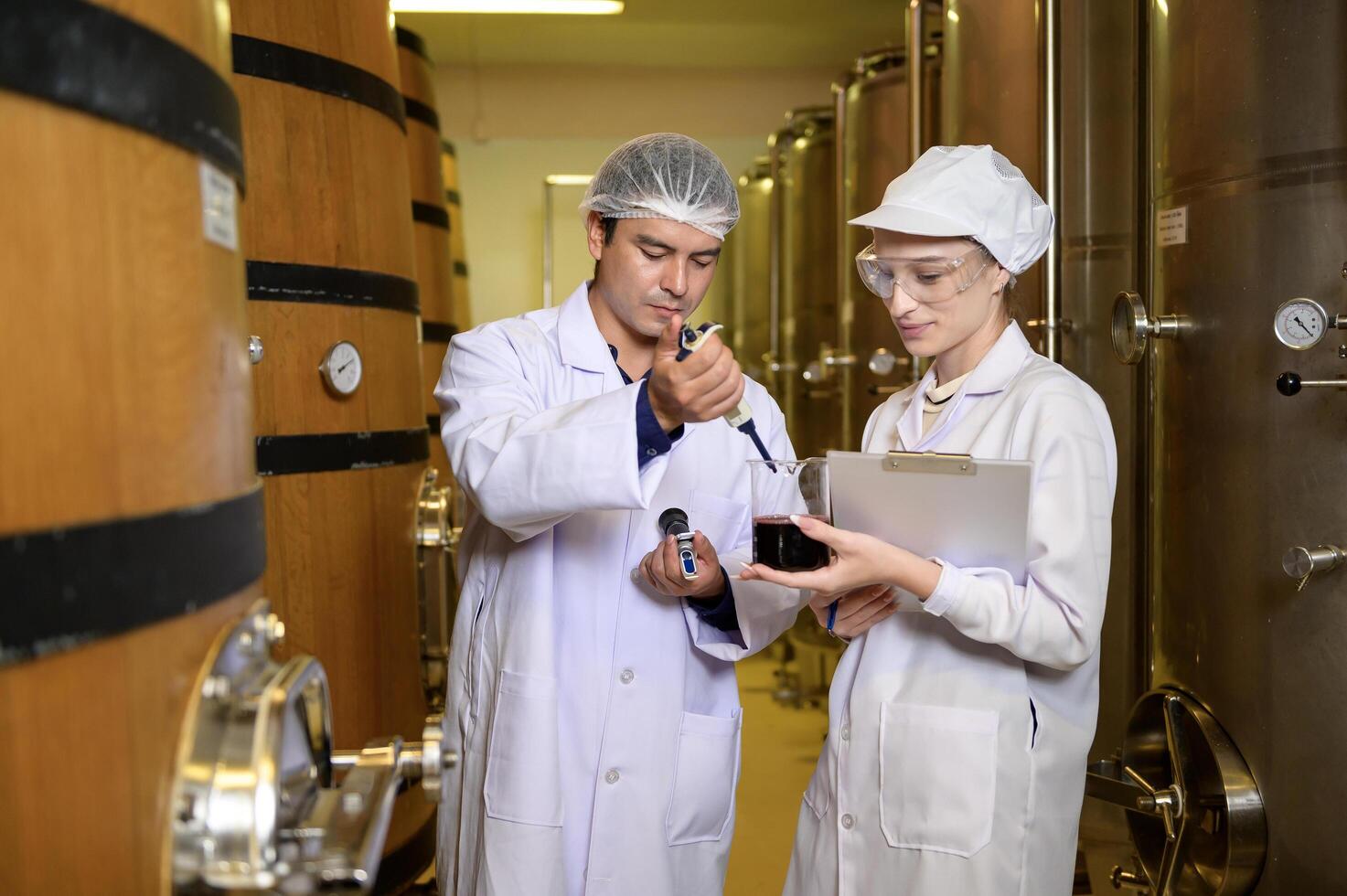 Professional winemaker controlling wine making process and quality at winery factory photo