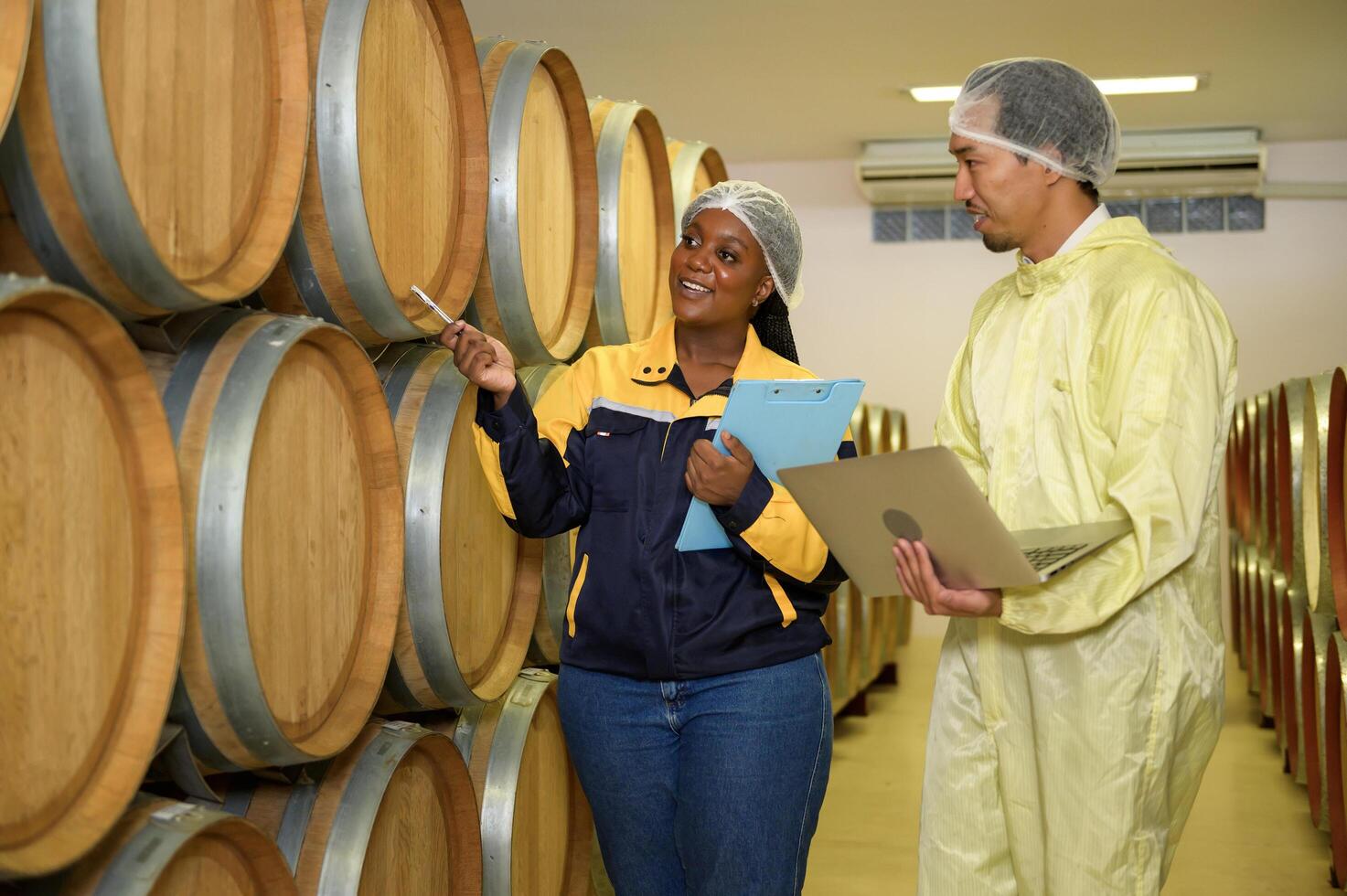 Professional winemaker controlling wine making process and quality at winery factory photo