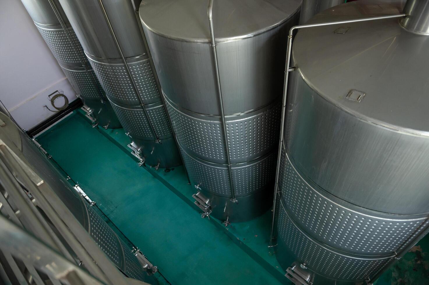 Wine fermentation tanks in modern wine factory photo