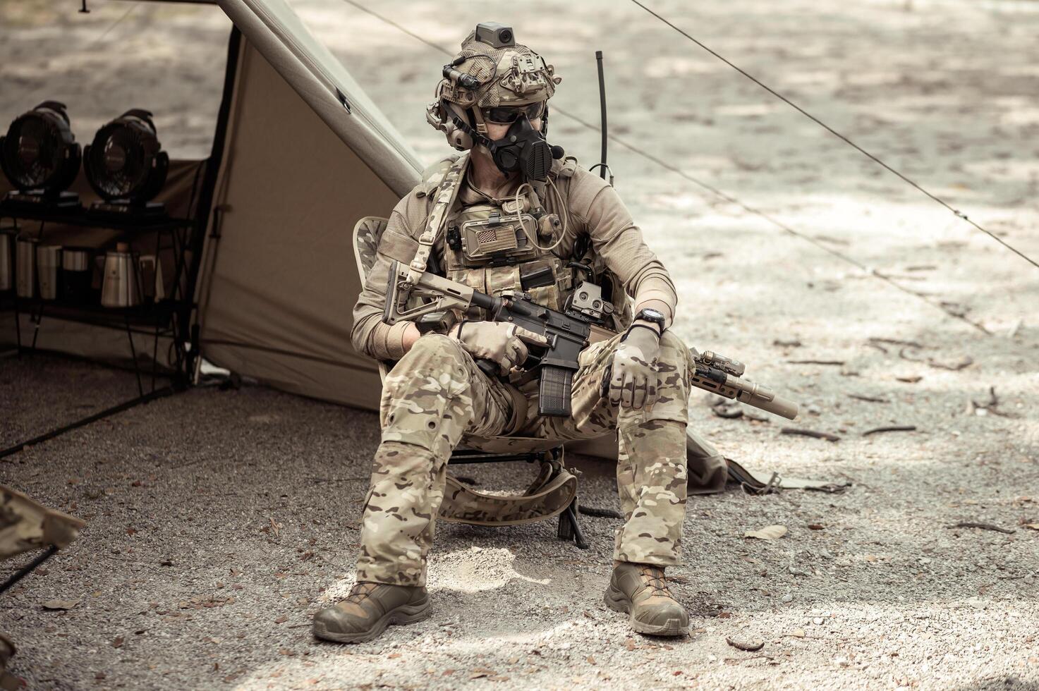 Soldiers in camouflage uniforms planning on operation in the camp, soldiers training in a military operation photo