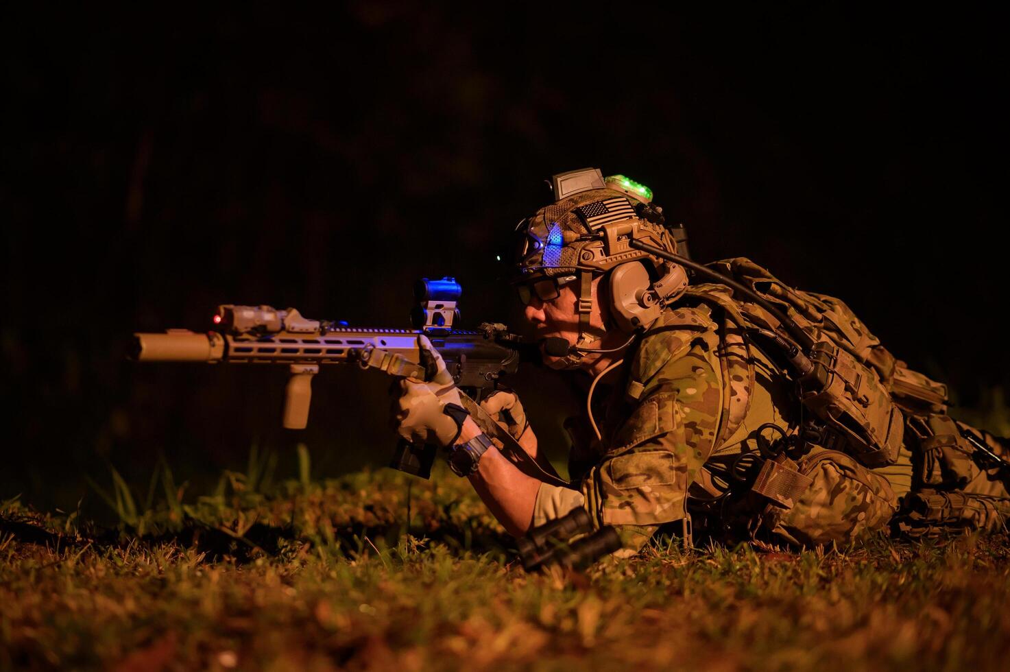 Soldiers in camouflage uniforms aiming with their riflesready to fire during Military Operation at night soldiers training in a military operation photo