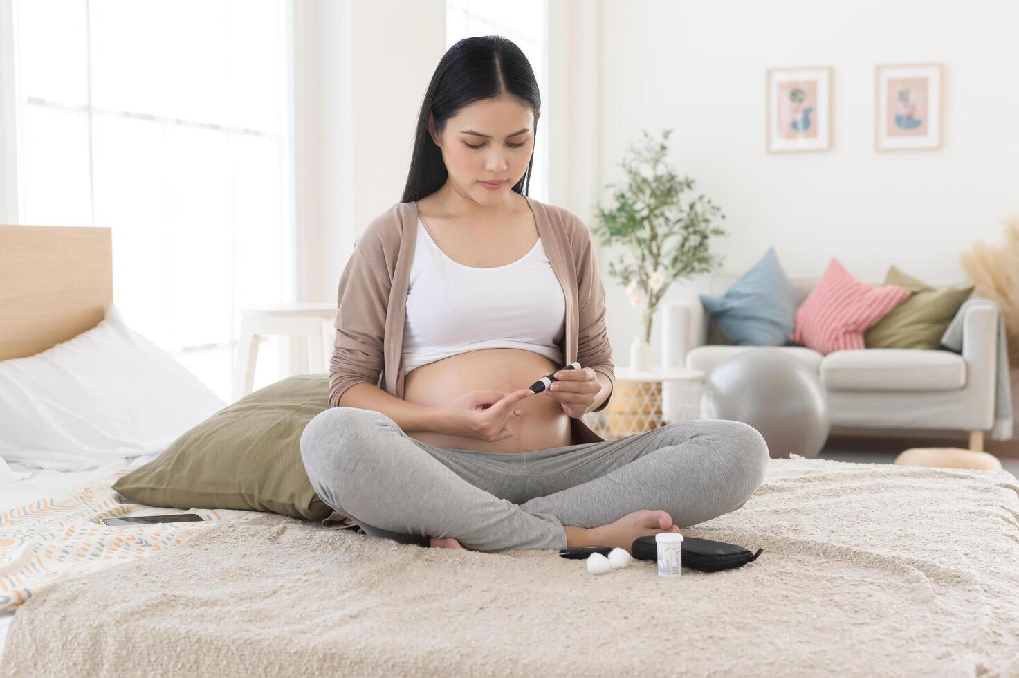 Pregnant woman checking blood sugar level by using Digital Glucose meter, health care, medicine, diabetes, glycemia concept photo