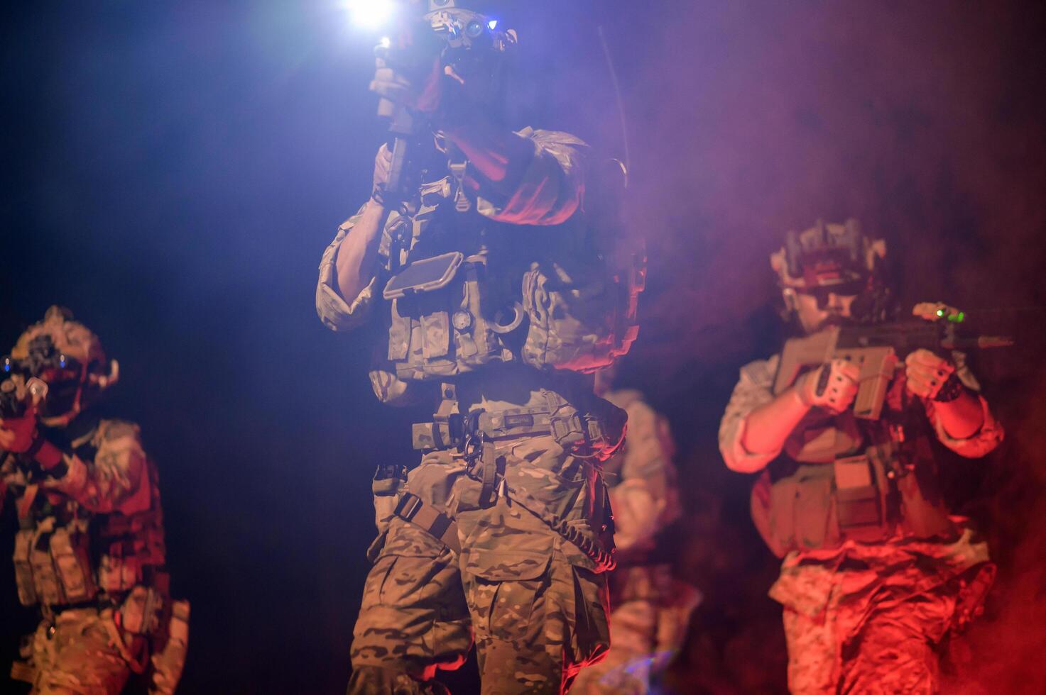 Soldiers in camouflage uniforms aiming with their rifles ready to fire during Military Operation at night, soldiers training in a military operation photo