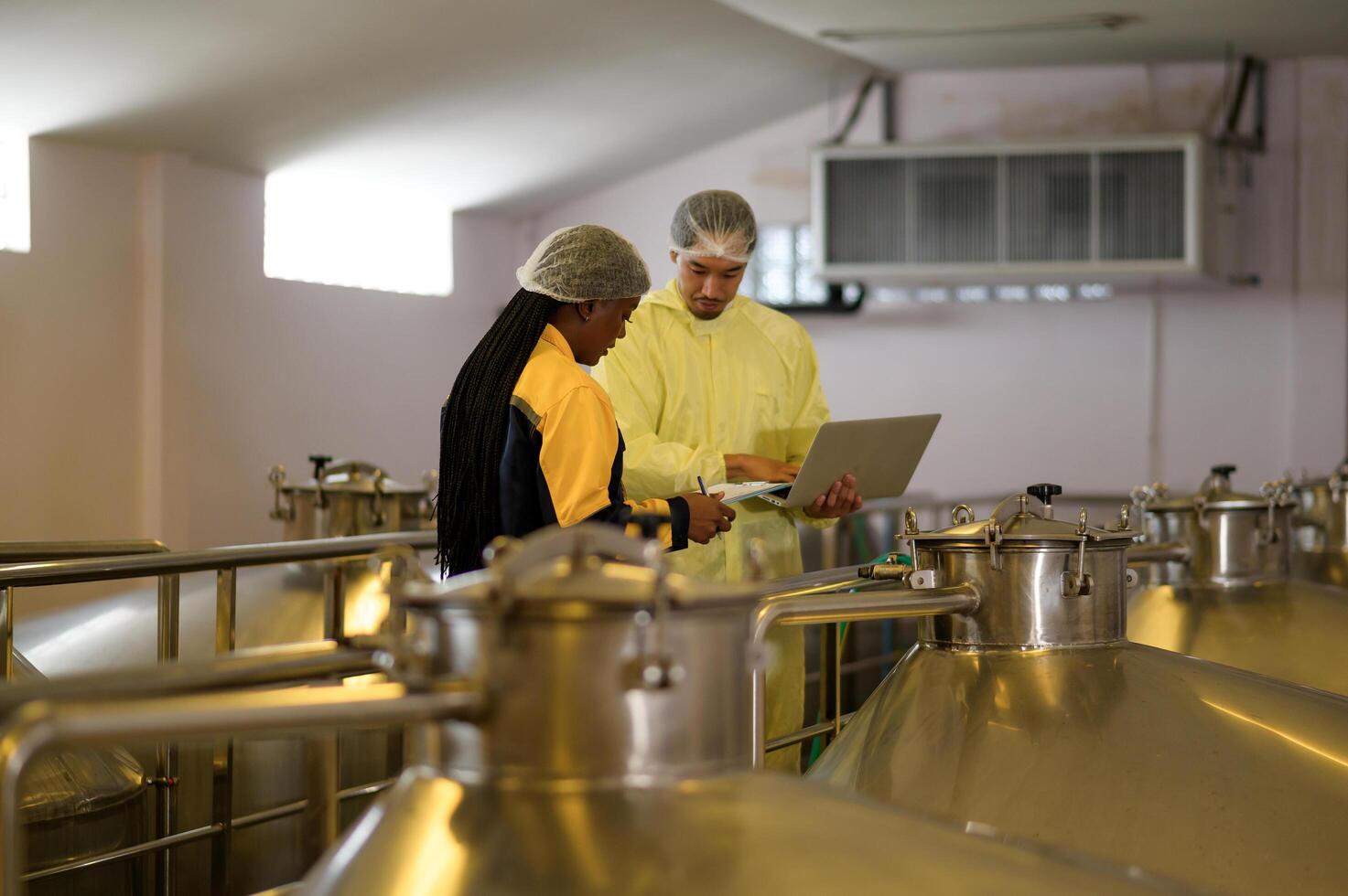 Professional winemaker controlling wine making process and quality at winery factory photo