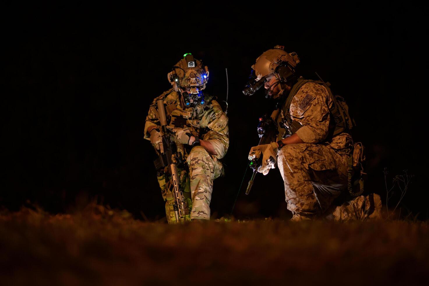 Soldiers in camouflage uniforms aiming with their rifles ready to fire during Military Operation at night, soldiers training in a military operation photo
