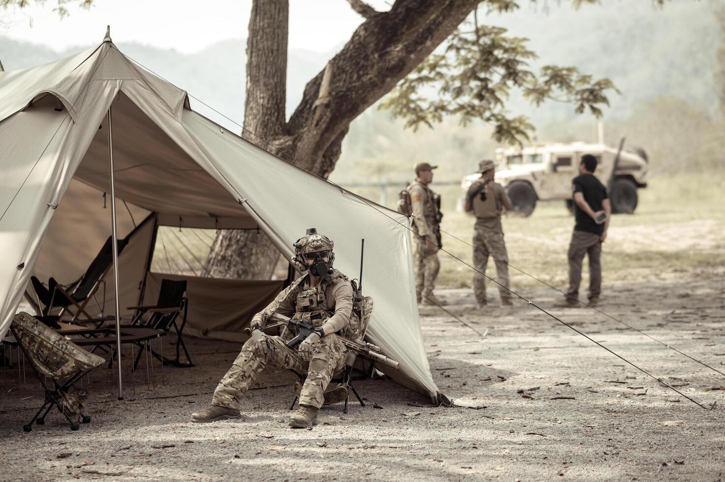 Soldiers in camouflage uniforms planning on operation in the camp photo
